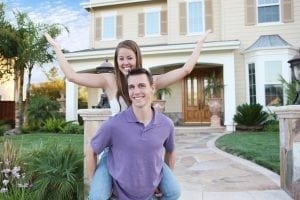 A young couple in love in front of their new home