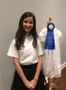 <em>Glen Iris Baptist School (GBIS) Junior Sara Young with the heirloom dress she designed and entered in the Alabama Christian Education Association (ACEA) Fine Arts competition winning first place in Garment Construction. She advances to the national competition this spring.</em>