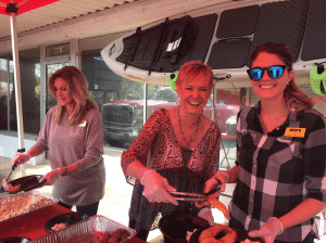 <em>The staff at Mark’s Outdoors greet customers with plates of free Whisker’s Catfish and fixings at Turkey Day.</em>