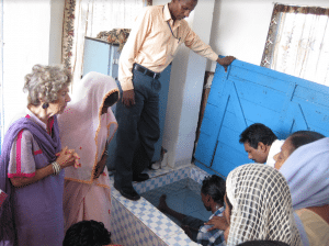 <em>Doris Slappey prays for the baptism of a new believer.</em>