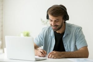 bigstock Smiling Man In Headphones Watc 243263074