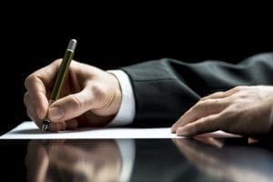 bigstock Businessman Writing A Letter O 57436670