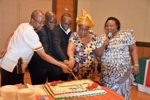 Janet Kinyua, Jacinta Ngigi, Father Mungai (New York), Father Daniel (Montgomery), Father Michael (Louisiana) cut a celebratory cake at the social following Mass in Swahili at Prince of Peace Catholic Parish.