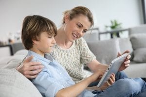 Epic Curriculum Mom and Son on Couch looking at iPad