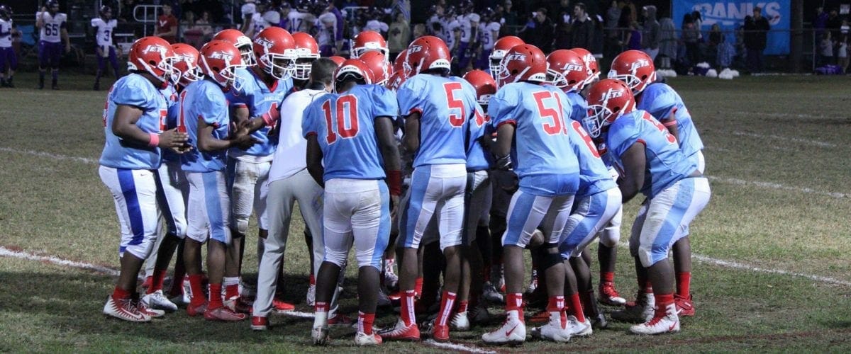 Team Huddle on Field Coach White