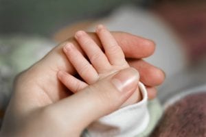 bigstock Close Up Babys Hand Put On Mom 287664790