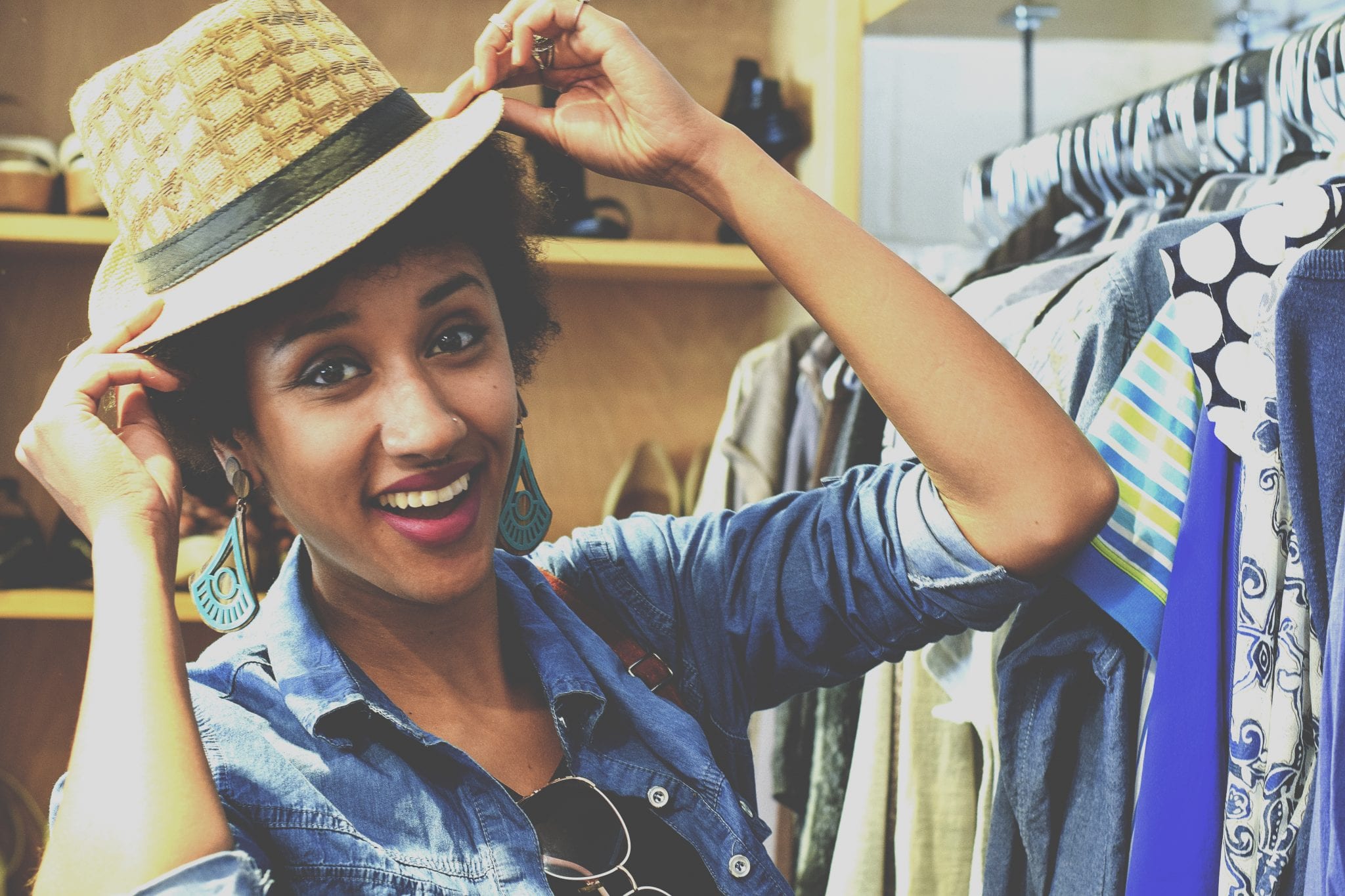 bigstock Woman Trying On A Hat 256141435