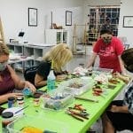 A Group of friends around a table creating art at Dixon Creative