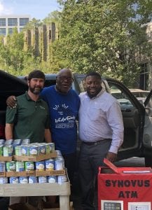 Mission makers Daniel Cason Ministries canned goods for Bread of Life from Synovus employees Cason center