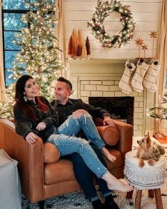 Charlotte and her husband Jon sitting by their fireplace