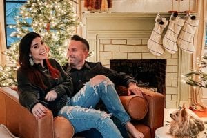 Charlotte and her husband Jon sitting by their fireplace