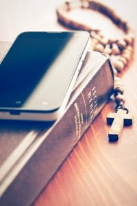 smartphone with holy bible and rosary PGVFUU5