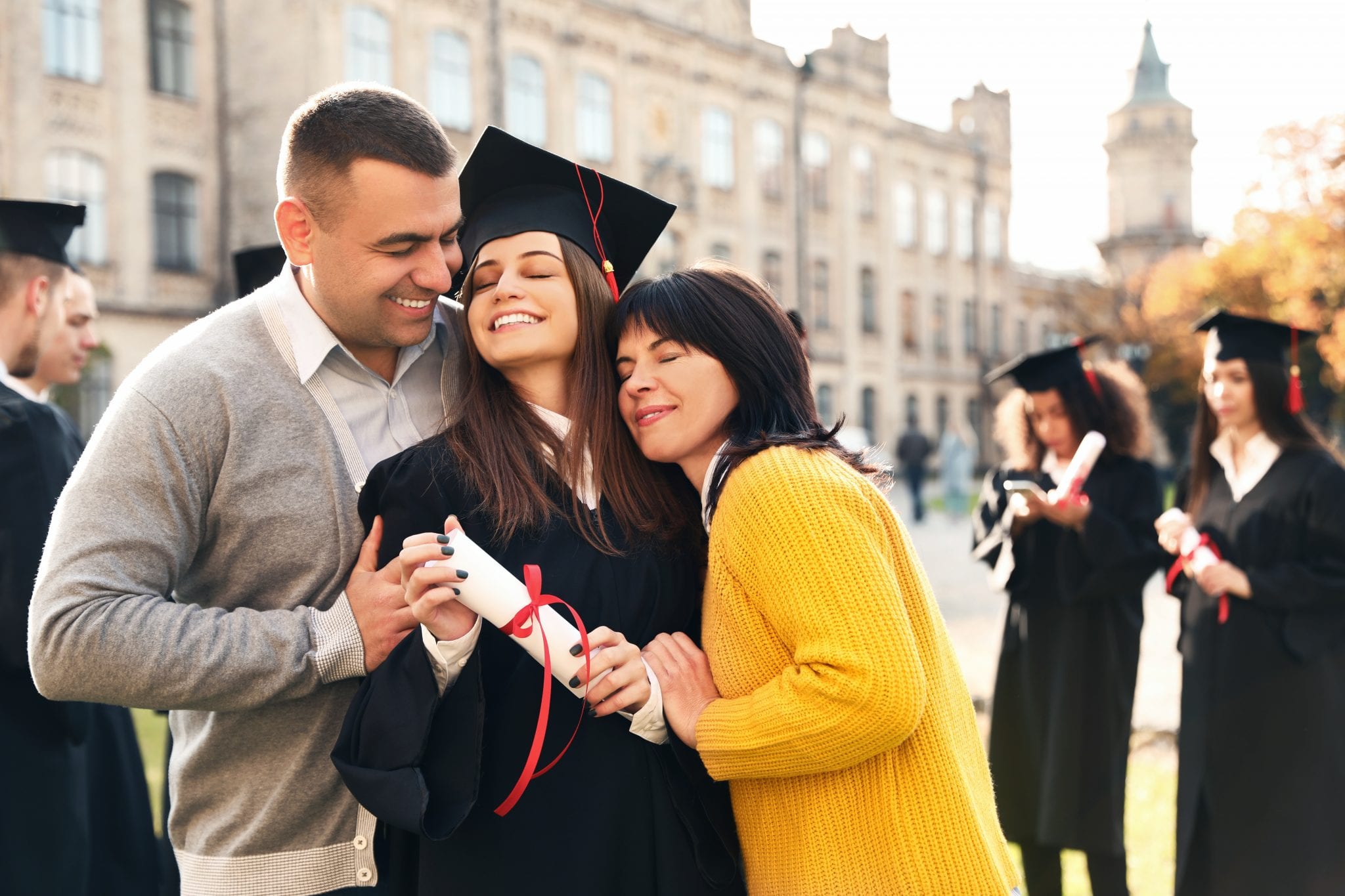 bigstock Happy Student With Parents Aft 329608783