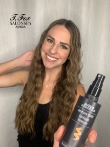 Stylist holding Texture Tonic Bottle