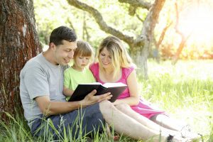 bigstock Happy Family Reading A Book On 420096673