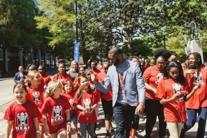 Mayor Woodfin with kids walking in Birmingham