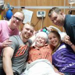 Miracle Moments Briklyn in hospital bed with family surrounding her
