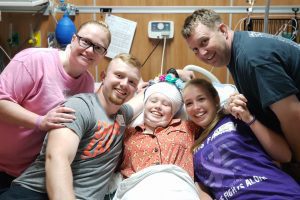 Miracle Moments Briklyn in hospital bed with family surrounding her