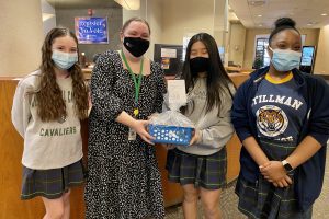 OLS Students with Library employee holding gift basket