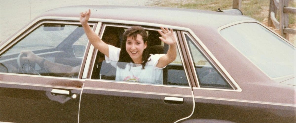 Ranell waving from car