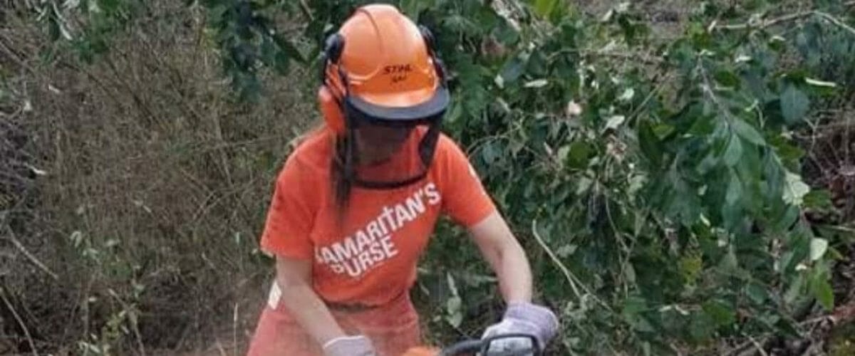 Janet using a chainsaw during disaster relief