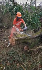 Janet using a chainsaw during disaster relief