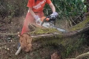 Janet using a chainsaw during disaster relief