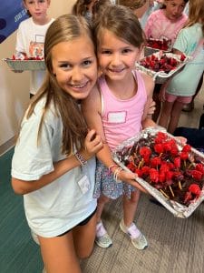 Poiema Summer Camp attendees holding craft