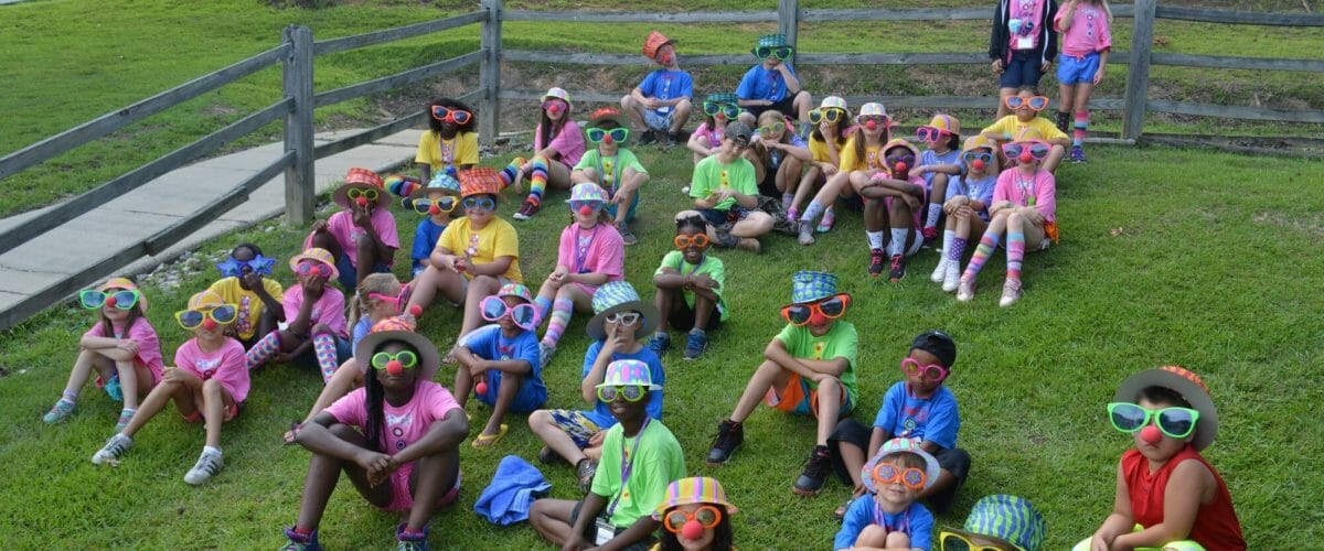 Royal Family Kids Camp campers sitting on hill