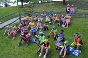 Royal Family Kids Camp campers sitting on hill