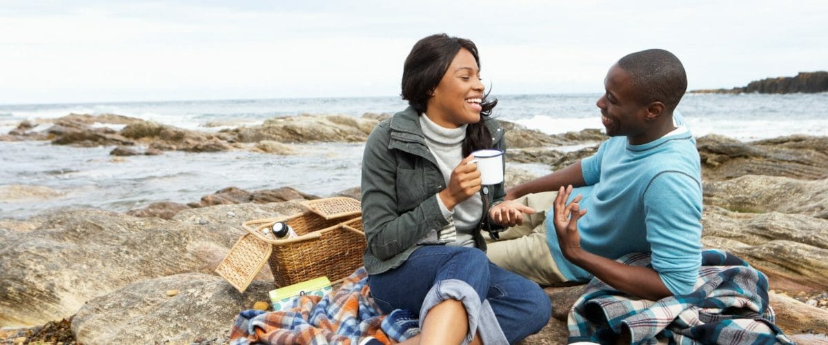 bigstock Couple having picnic on beach 27386420