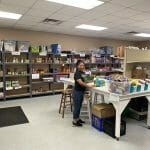 The Grace Place pantry with volunteer
