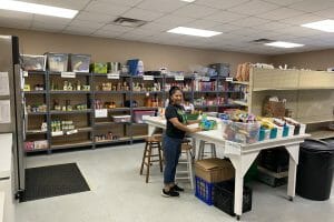 The Grace Place pantry with volunteer