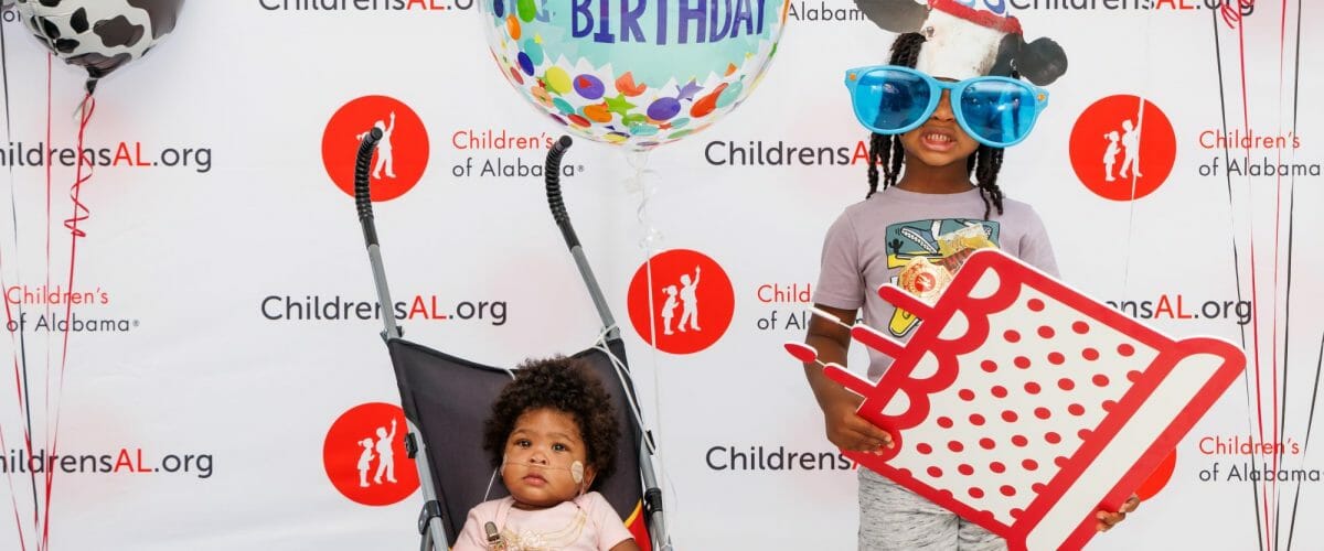 Children posing for photo at Children's of Alabama party