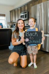 Heather Brown and son holding a back to school sign