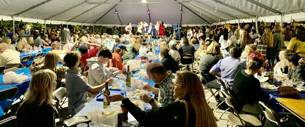 Greek festival tent with people eating