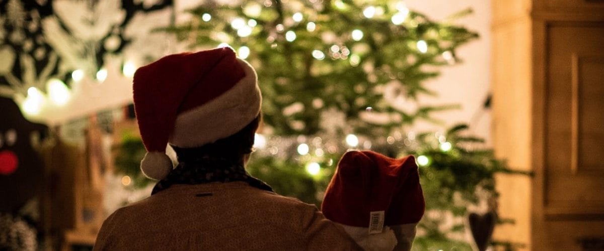 mom and child looking at christmas tree