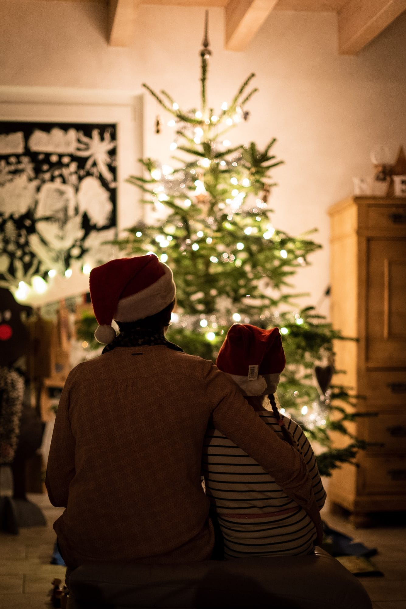 mom and child looking at christmas tree