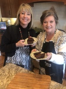 Laurie and Danna with brownies in kitchen