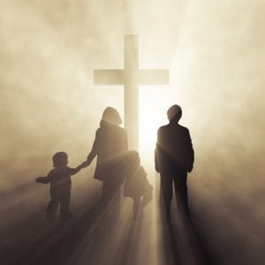 christian family before a cross
