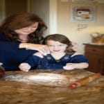1Danna and grandchild in kitchen with rolling pin