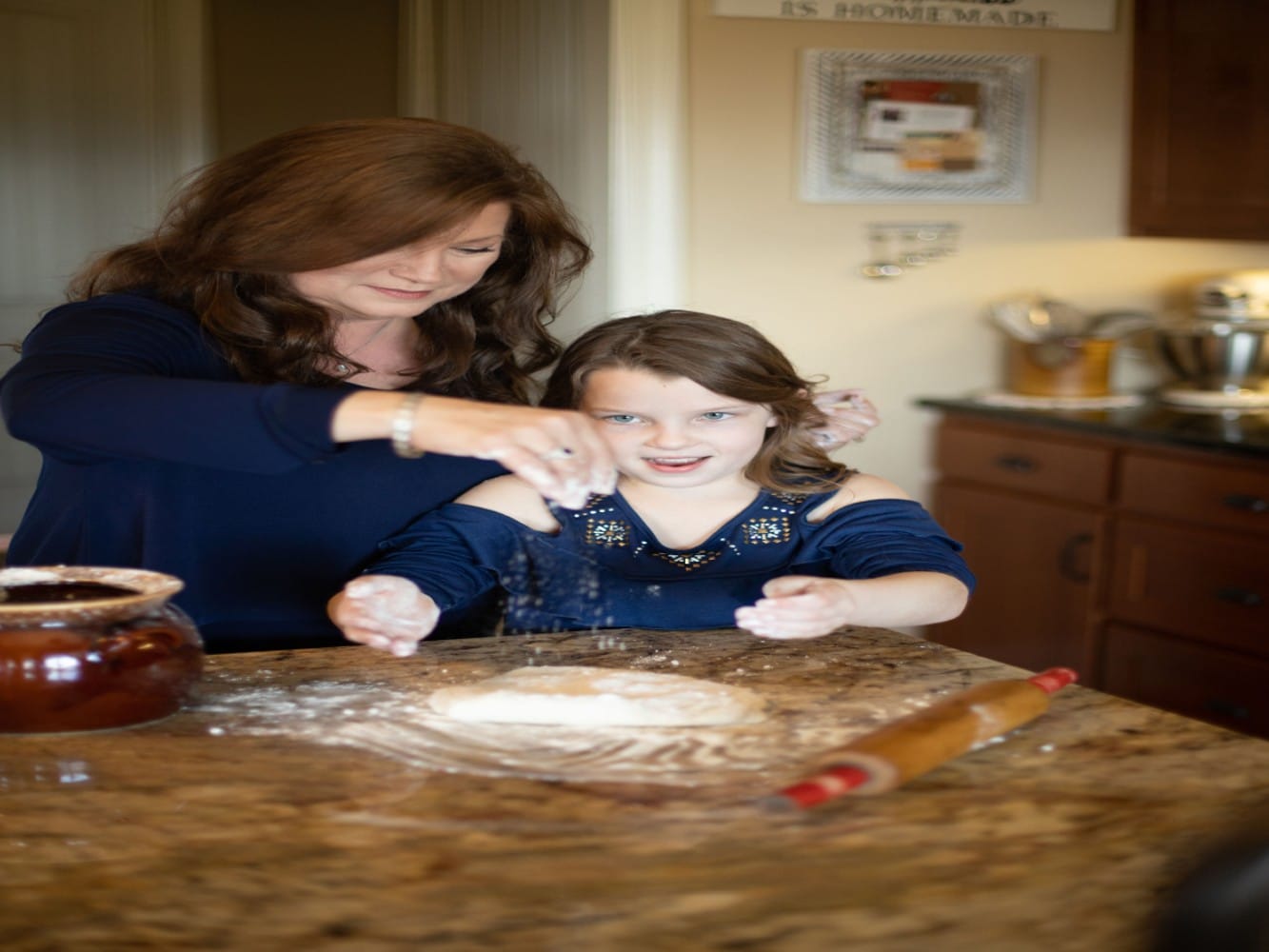 1Danna and grandchild in kitchen with rolling pin