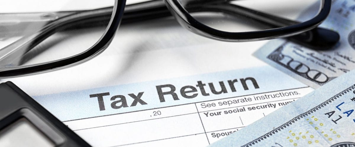 bigstock Tax return form glasses calc 180532114