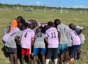 Children pray together during discipleship league at a Vapor center in Haiti