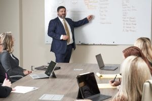 Steven Mezrano talking in front of white board