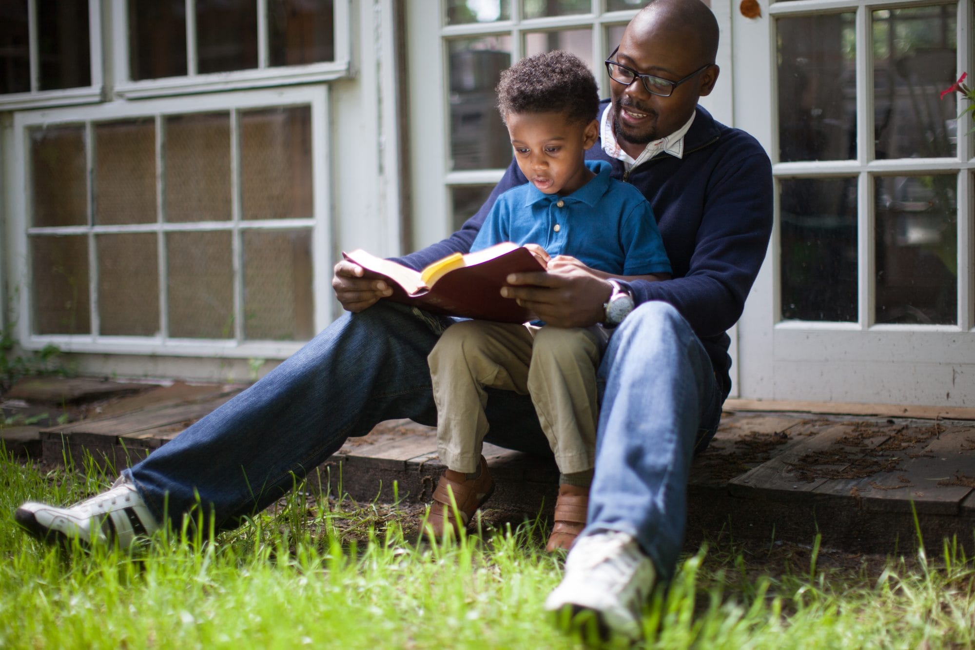 father and son reading together