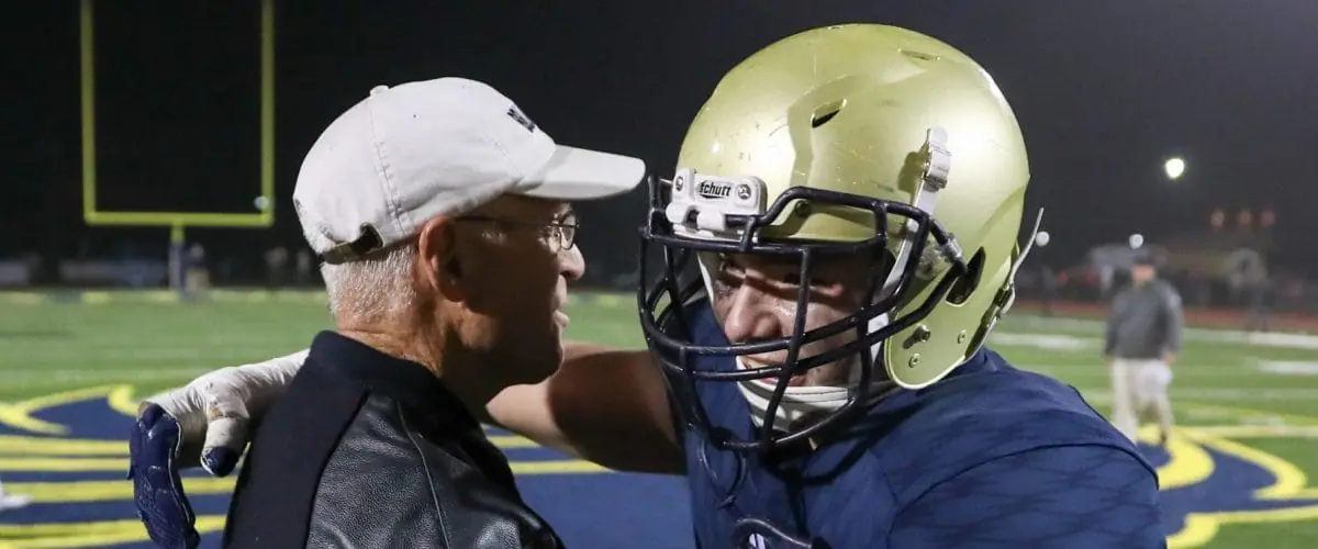 Coach Yancey hugging player