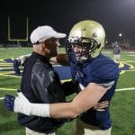 Coach Yancey hugging player