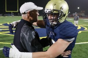 Coach Yancey hugging player