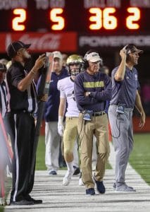 Coach Yancey walking on sidelines